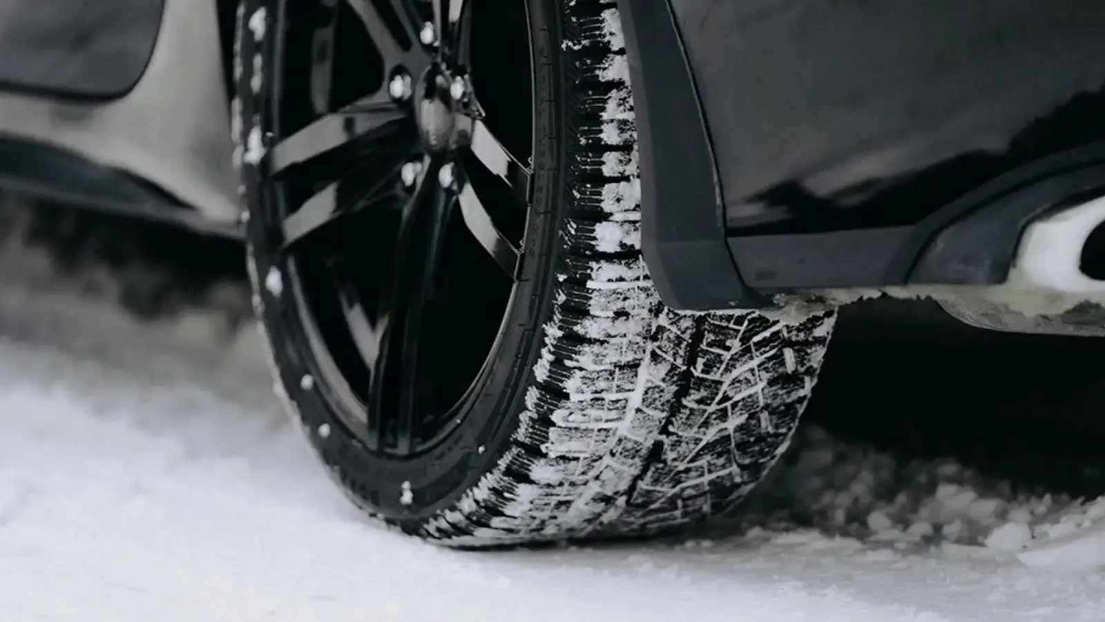 SUV equipped with winter tires effectively navigating through a snowy landscape.